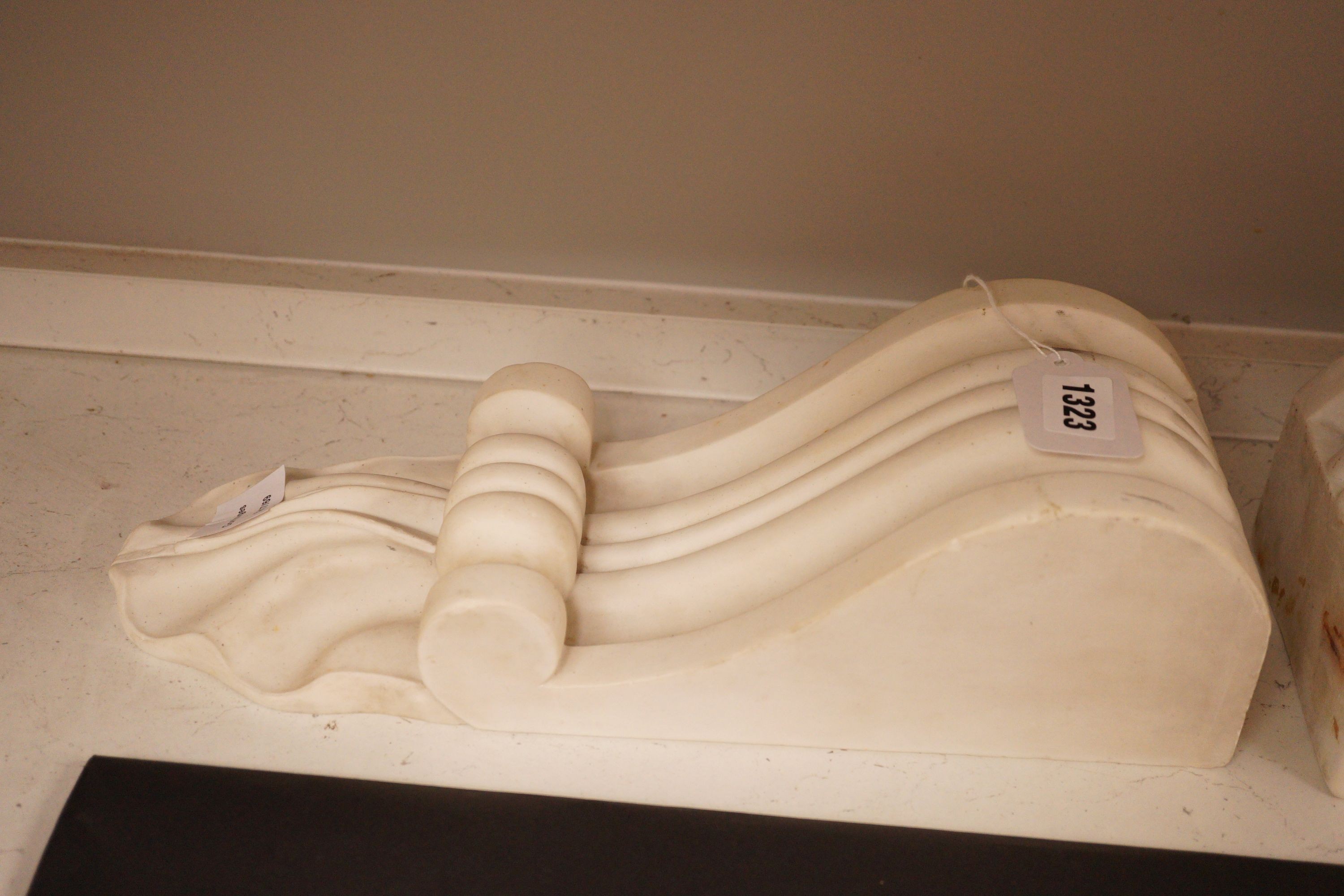 A pair of carved white marble scrolling corbels, 38x14cm